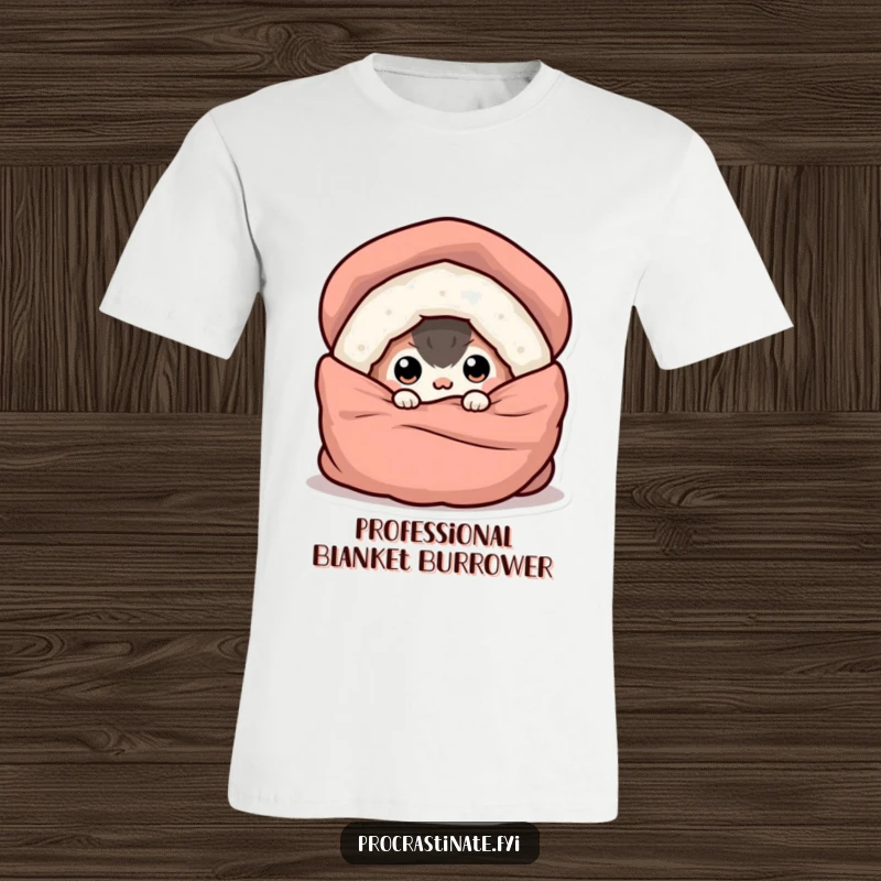 Funny t-shirt depicting a round creature buried under a blanket, with only its wide eyes peeking out, embracing comfort.