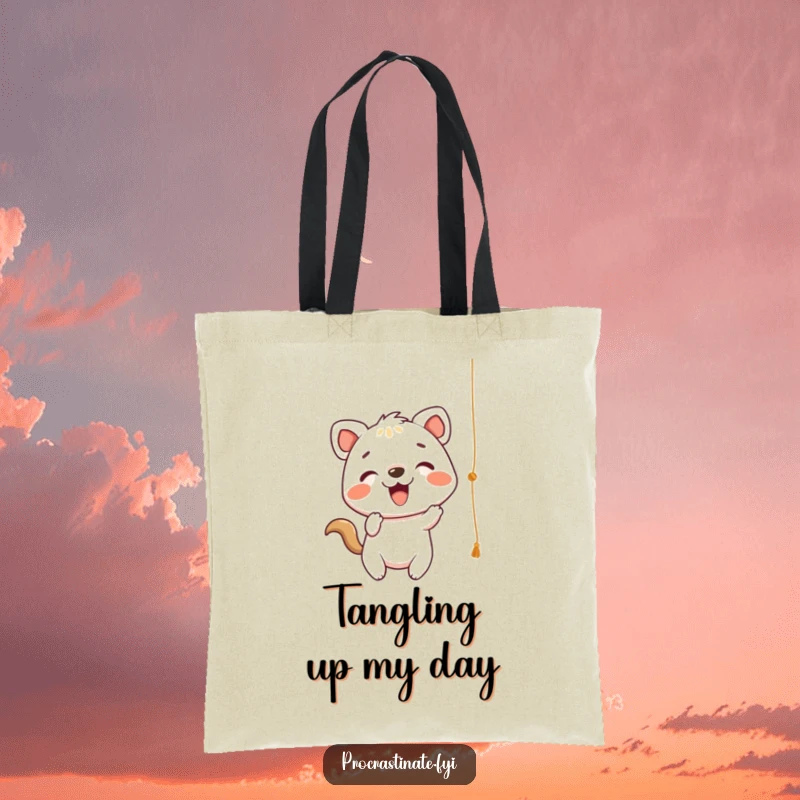 Funny Tote Bag showcasing a cheerful animal character playfully batting at a dangling string, a whimsical and practical accessory.